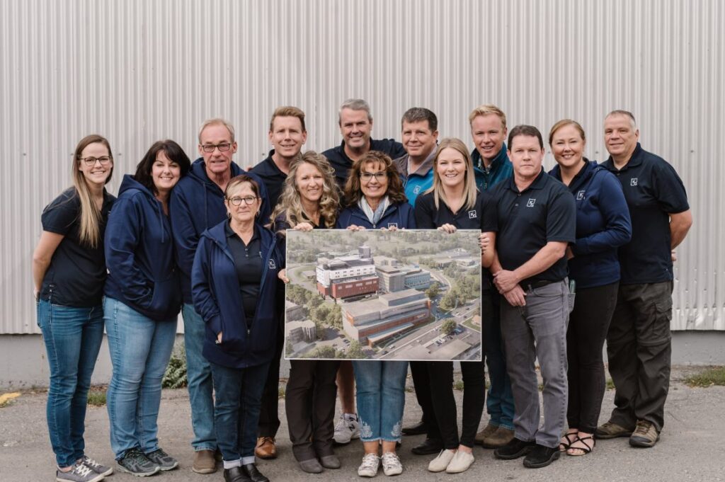 Kelson Group staff with photo of Royal Inland Hospital