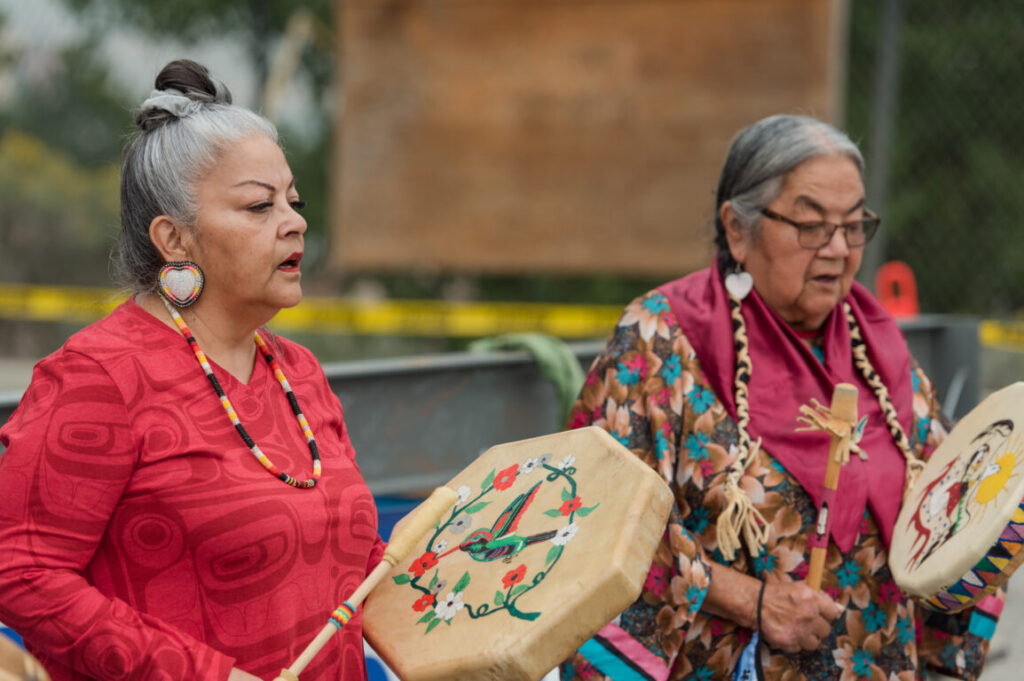 Women drumming at patient care tower