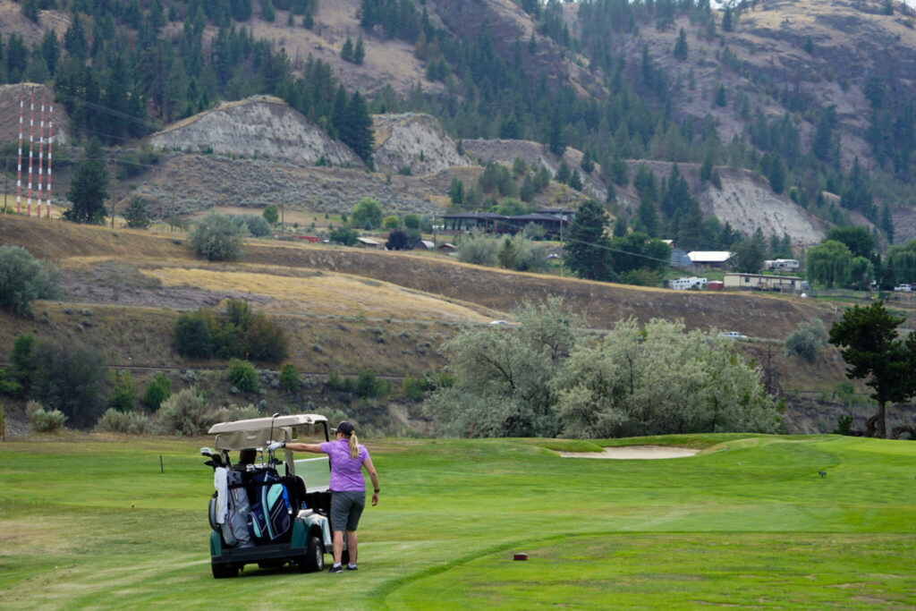 Woman golfing at 25th annual SCT&I charity golf tournament