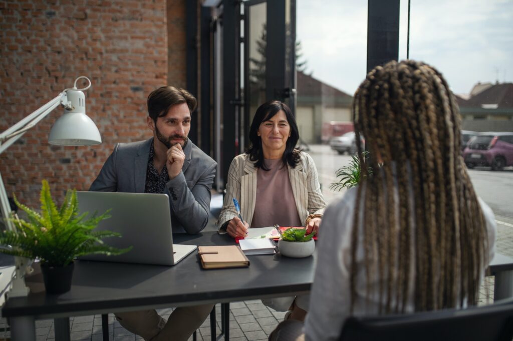 Rear view of young woman having job interview in office, business and career concept